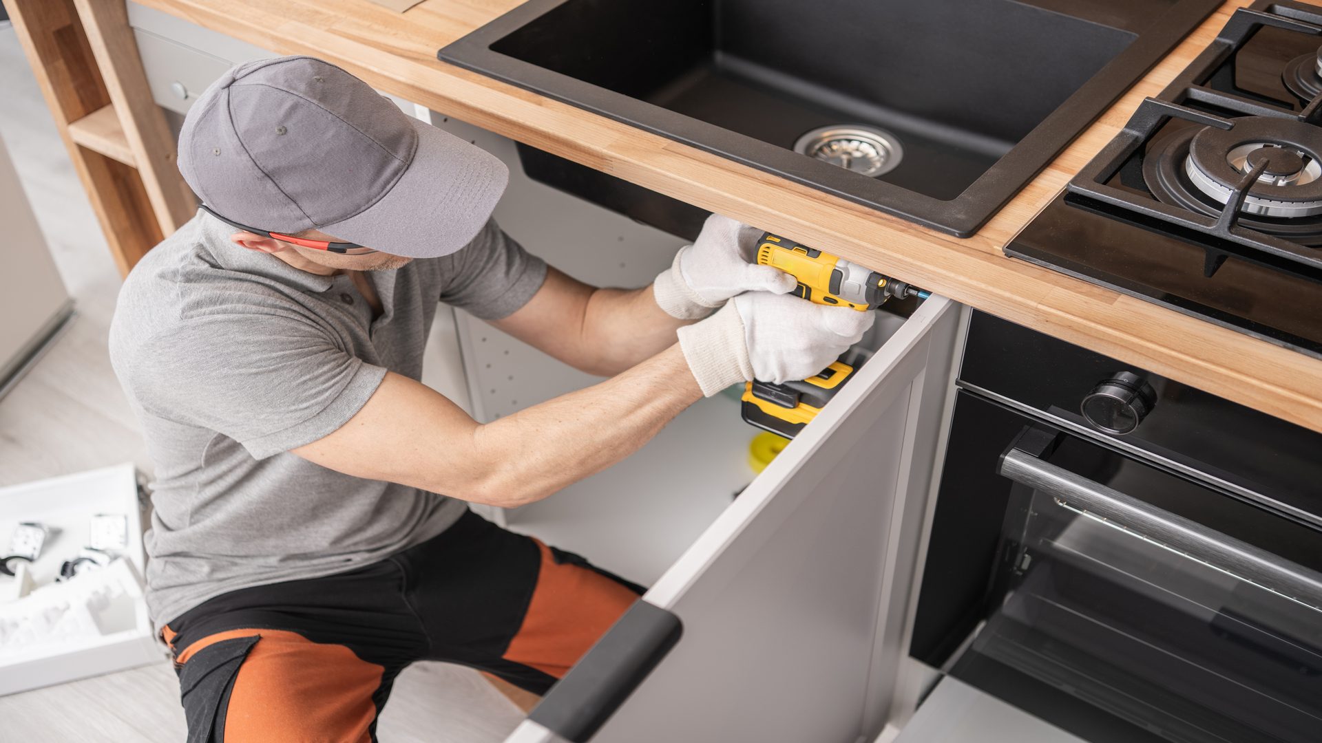 Caucasian,Professional,Cabinetmaker,In,His,40s,Assembling,Kitchen,Cabinets,Furniture